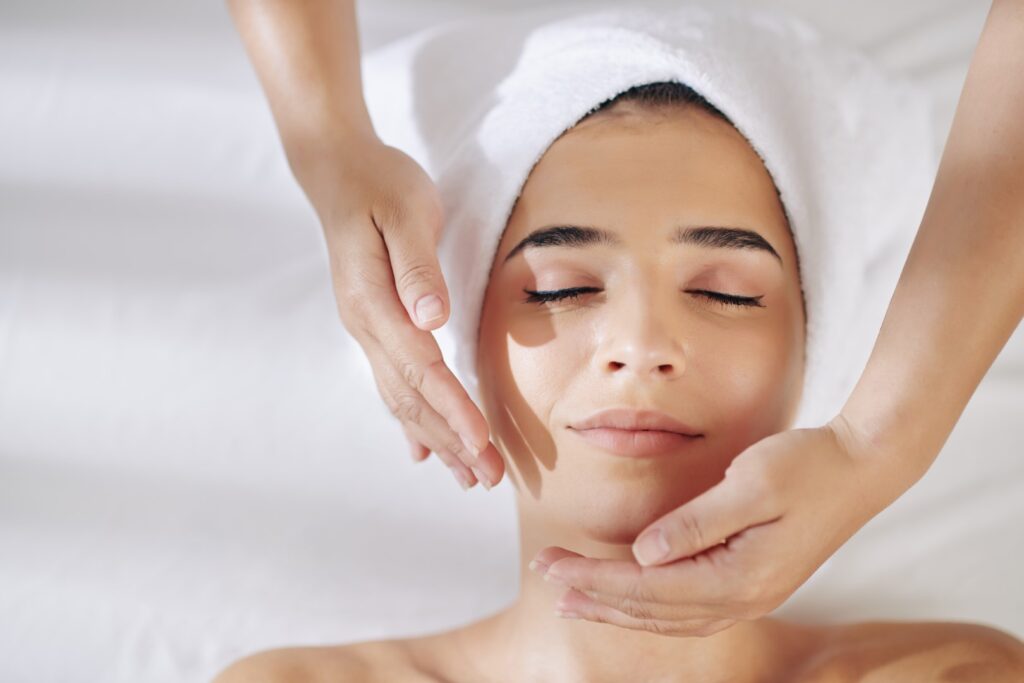 woman receiving the benefits of regular facials for glowing skin